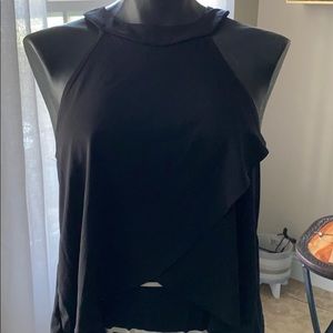 A black sleeveless top with a crossover design.